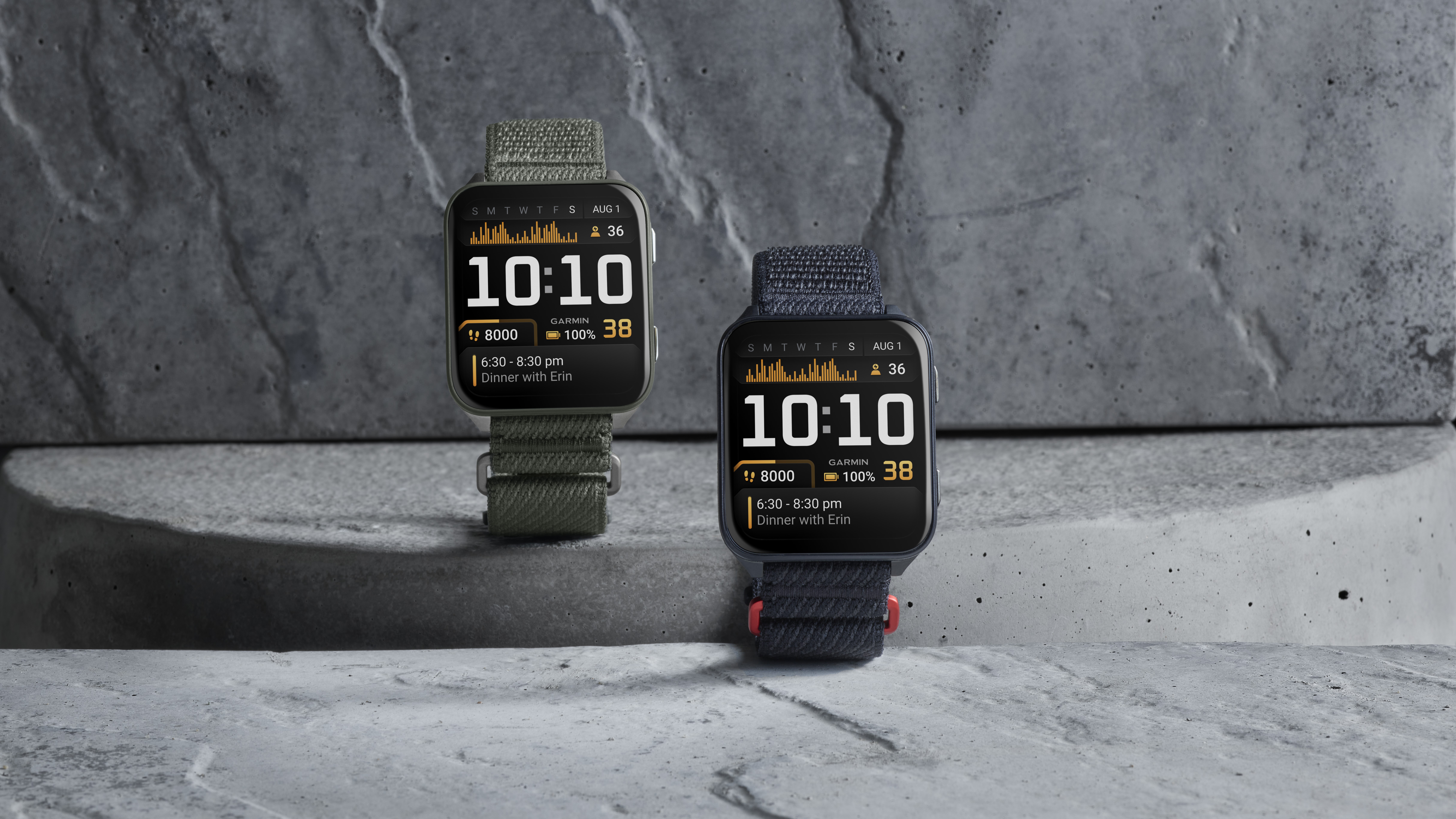 Photo of two Garmin Venu X1 models, the Black with Slate Titanium Caseback and Black ComfortFit Nylon Band and Moss with Titanium Caseback and Moss ComfortFit Nylon Band.