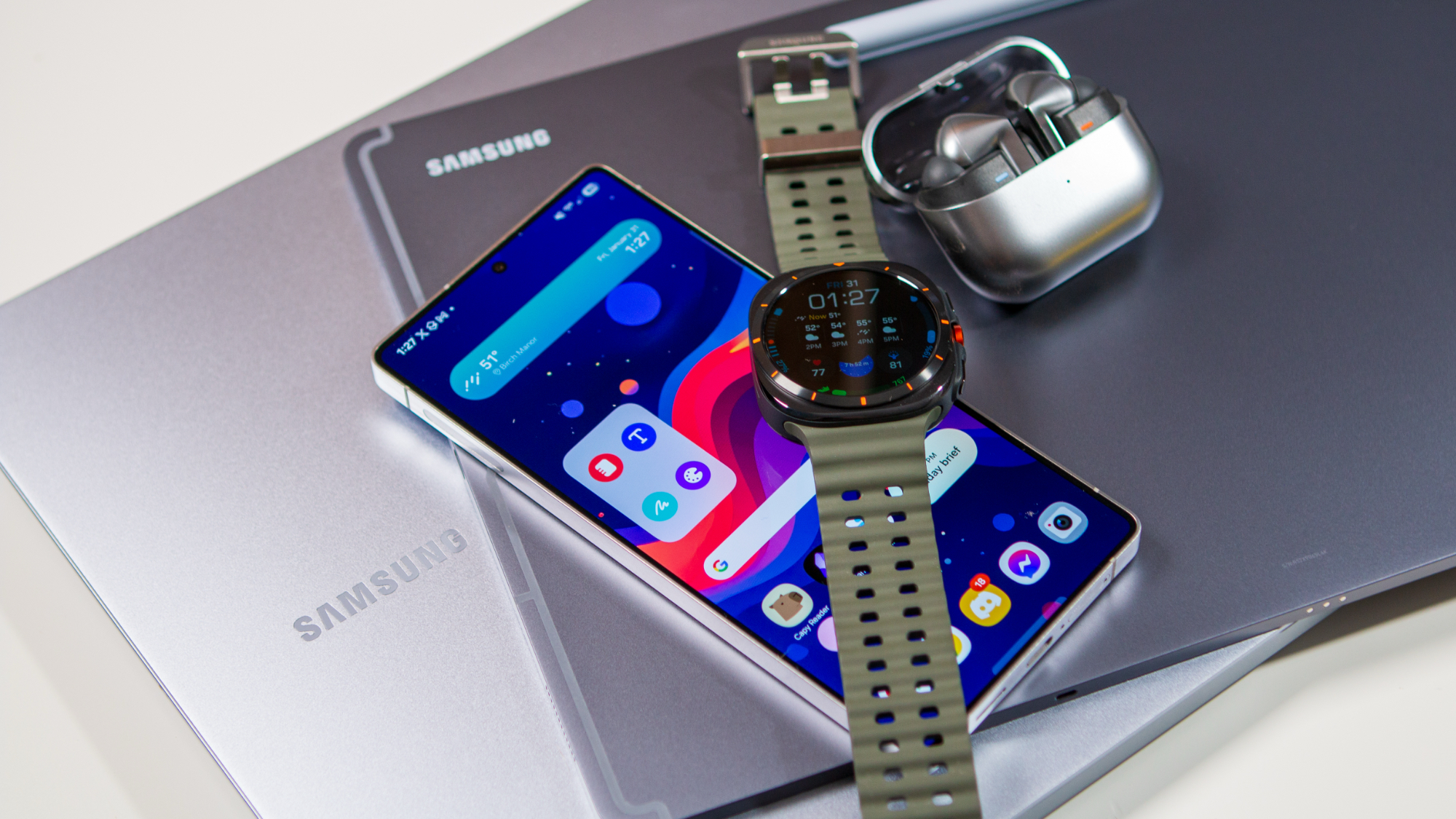 Samsung ecosystem of devices including the Galaxy S25 Ultra, Galaxy Watch Ultra, Buds 3 Pro, Samsung laptop, and Tab S10 Ultra